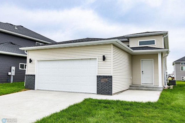 view of front facade with a garage and a front lawn