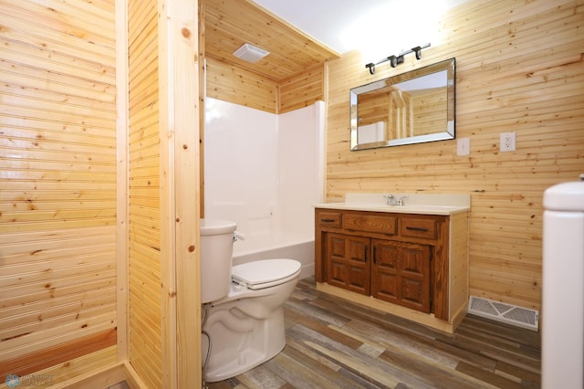 full bathroom featuring hardwood / wood-style floors, toilet, independent shower and bath, wood walls, and vanity