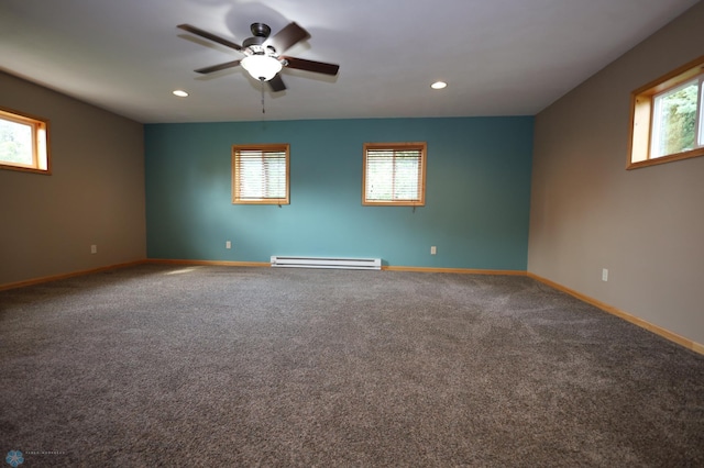 spare room featuring a wealth of natural light, baseboard heating, carpet floors, and ceiling fan