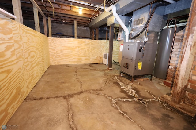 basement with brick wall, heating unit, and water heater