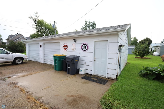 garage featuring a lawn