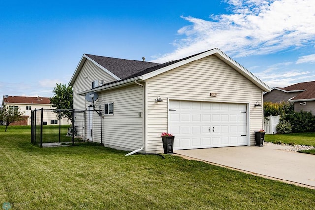 view of side of property with a garage and a lawn