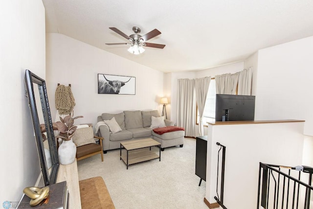 carpeted living room featuring ceiling fan and vaulted ceiling