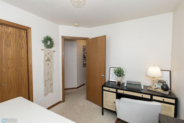 interior space featuring a textured ceiling and light colored carpet