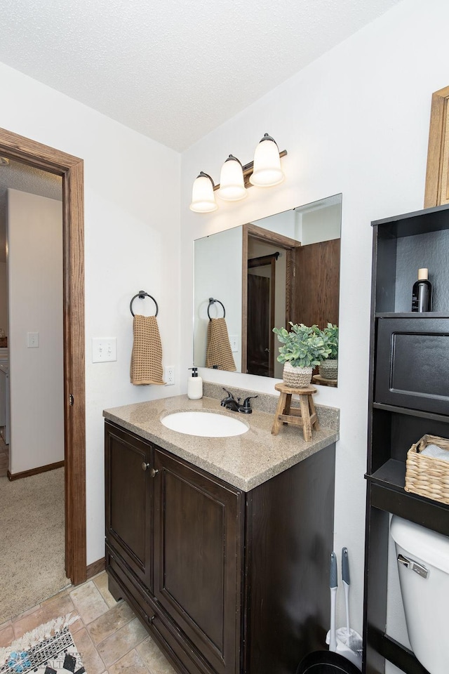 bathroom featuring vanity, toilet, and tile patterned floors