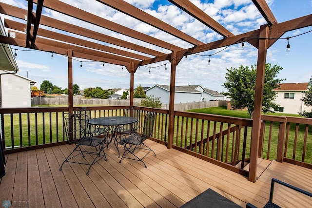 wooden terrace with a lawn and a pergola