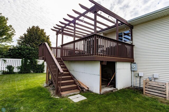 back of house featuring a wooden deck, a yard, and a pergola