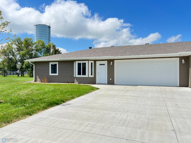 ranch-style house with a garage and a front lawn