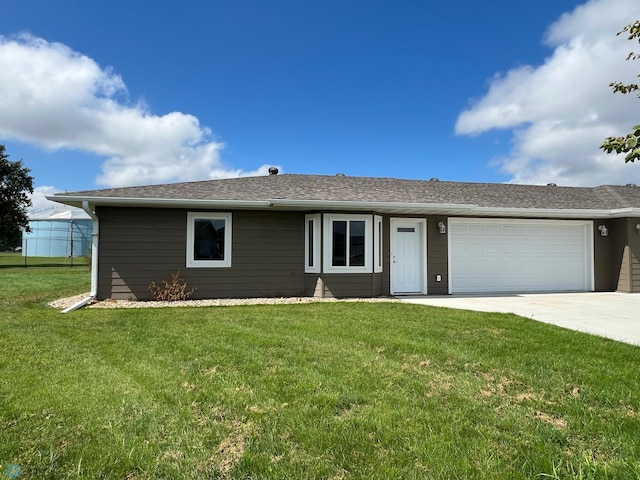 ranch-style house with a garage and a front yard