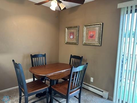 carpeted dining room featuring baseboard heating and ceiling fan