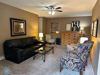 carpeted living room featuring ceiling fan