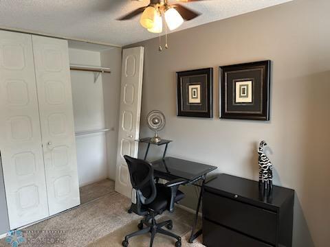 office space featuring carpet and ceiling fan