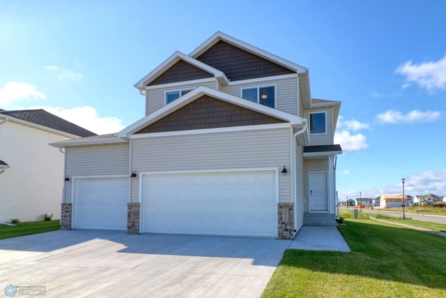 craftsman house featuring a front yard and a garage