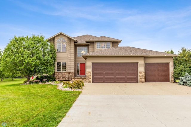 prairie-style house featuring a front lawn and a garage