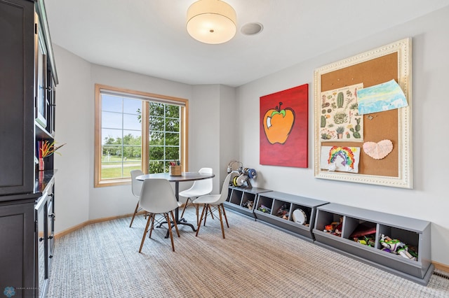 dining space featuring light carpet