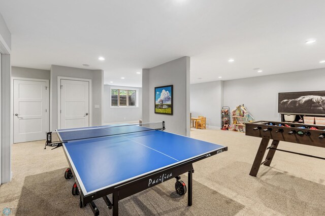 recreation room featuring light colored carpet