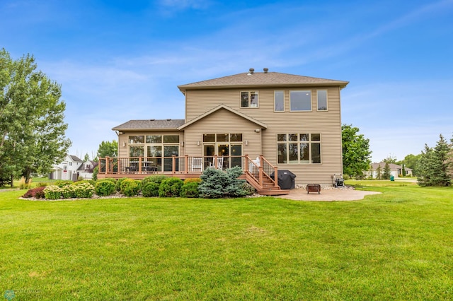 back of house with a yard, a patio area, and a deck