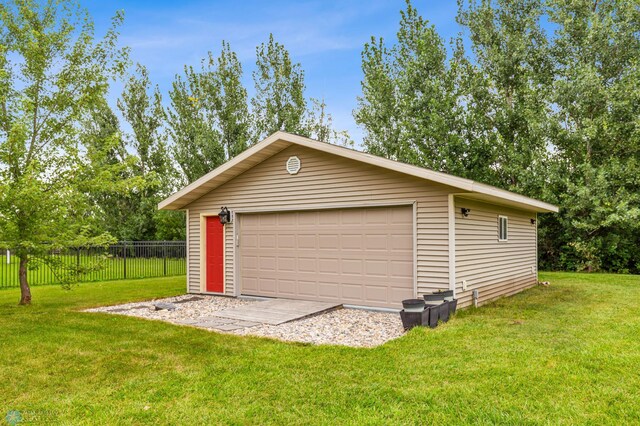 garage featuring a lawn