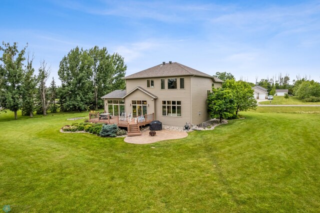 back of house featuring a patio, a deck, and a lawn