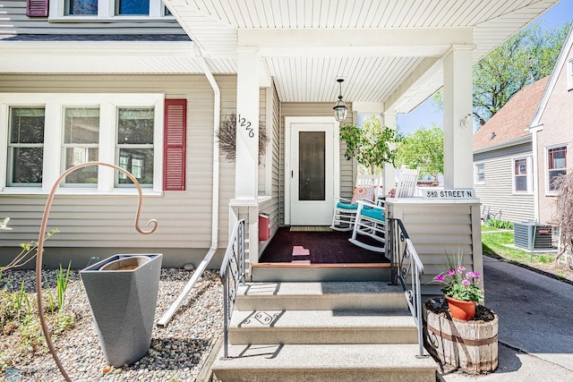 property entrance featuring a porch and central air condition unit