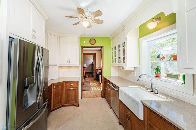 kitchen featuring light hardwood / wood-style flooring, appliances with stainless steel finishes, white cabinetry, ceiling fan, and tasteful backsplash