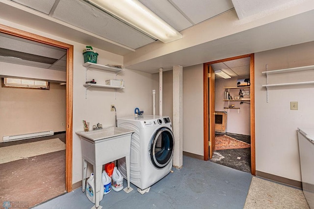 clothes washing area with washer / dryer and a baseboard heating unit