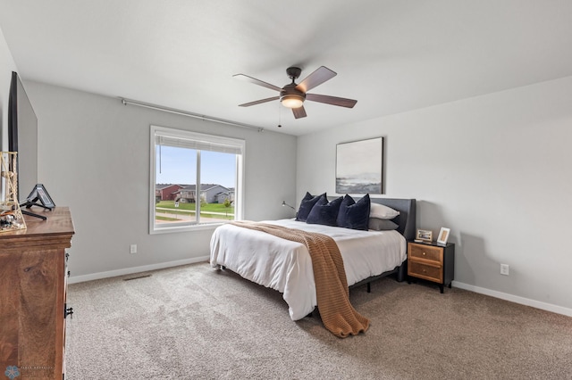 bedroom with ceiling fan and carpet floors