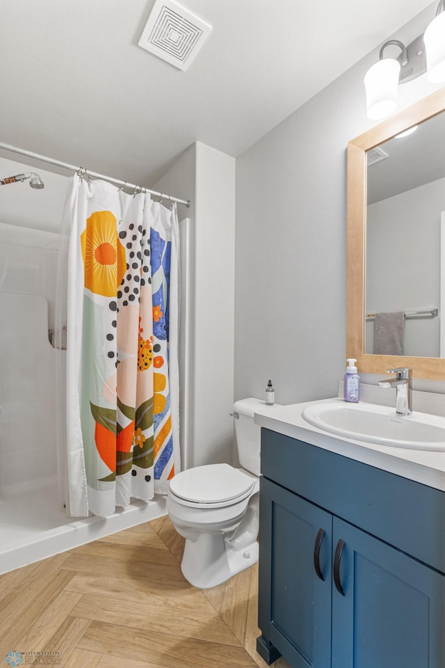 bathroom featuring vanity, toilet, parquet flooring, and walk in shower