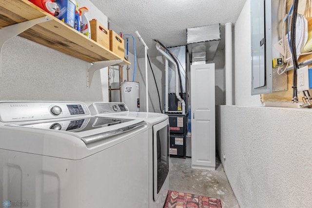 clothes washing area with washer and dryer, a textured ceiling, and electric water heater