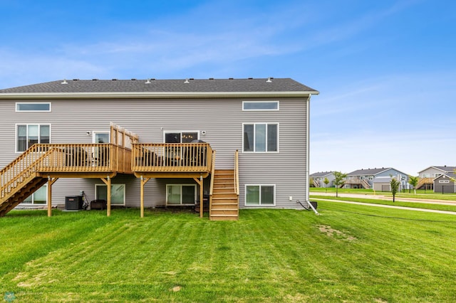 rear view of property featuring a yard, a deck, and central AC