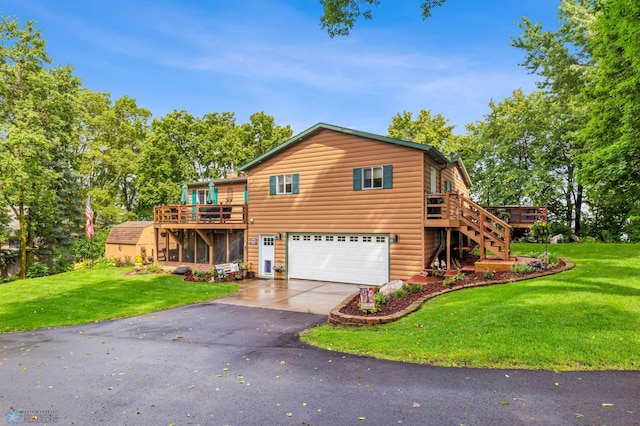 view of front facade with a garage, a front yard, and a wooden deck