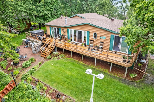 back of house featuring a yard and a wooden deck