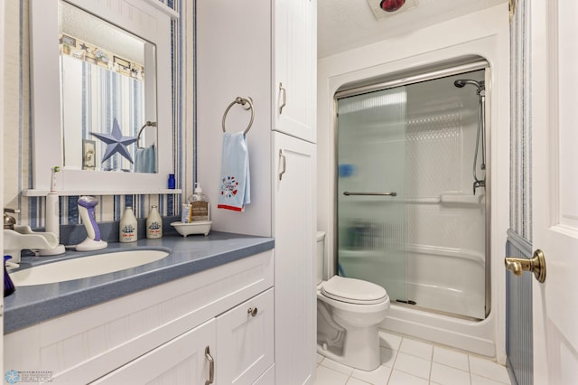 bathroom featuring toilet, tile patterned floors, vanity, a textured ceiling, and a shower with shower door