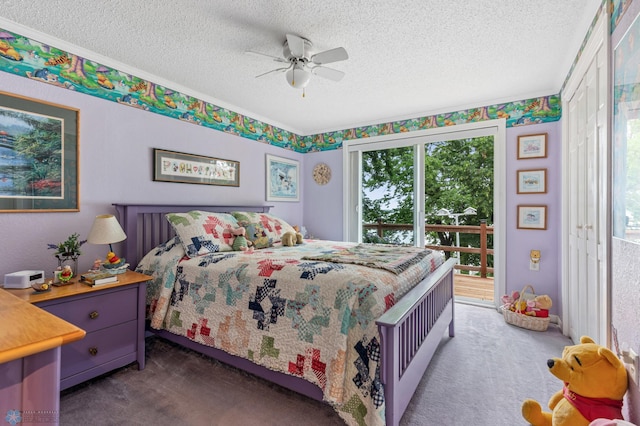 carpeted bedroom with ceiling fan, access to exterior, and a textured ceiling