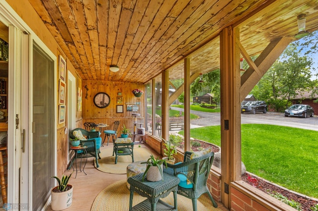 sunroom featuring wood ceiling