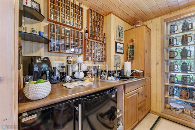 kitchen featuring dishwasher, light tile patterned floors, wood ceiling, sink, and wooden walls