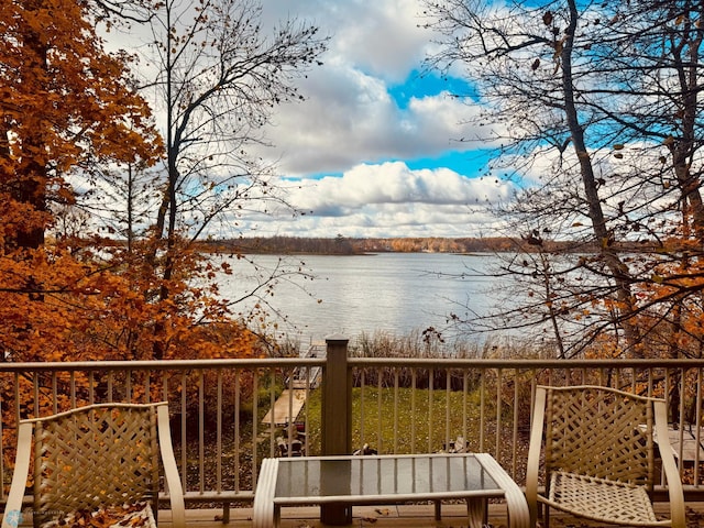 wooden terrace featuring a water view