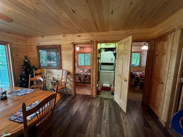 dining area with ceiling fan, wooden walls, dark wood-type flooring, and wood ceiling