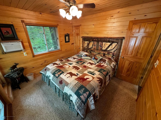 bedroom featuring ceiling fan, carpet floors, wood ceiling, and wood walls