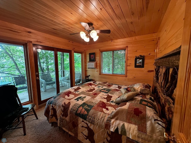 bedroom with ceiling fan, wooden ceiling, carpet floors, access to outside, and wood walls