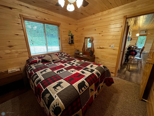 bedroom featuring wood walls, wooden ceiling, and ceiling fan