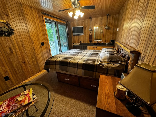 bedroom with wood walls, wood ceiling, and access to outside