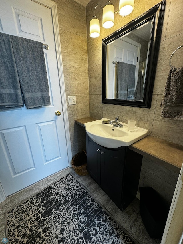 bathroom with tile patterned flooring, tile walls, and vanity