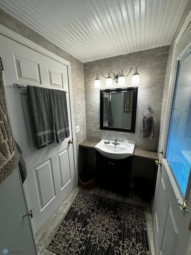 bathroom featuring vanity, tile walls, and tile patterned flooring