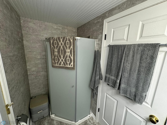 bathroom with tile walls and an enclosed shower