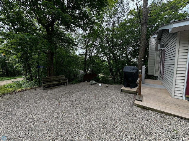 view of yard featuring a wooden deck and a patio area