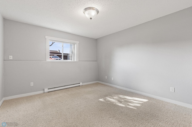 carpeted empty room with a baseboard heating unit and a textured ceiling