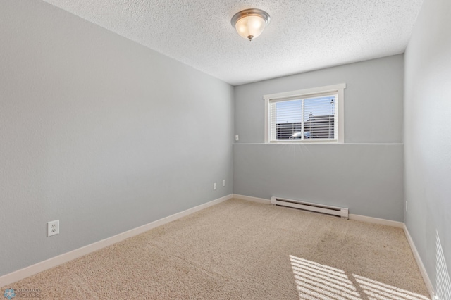 carpeted spare room featuring baseboard heating and a textured ceiling