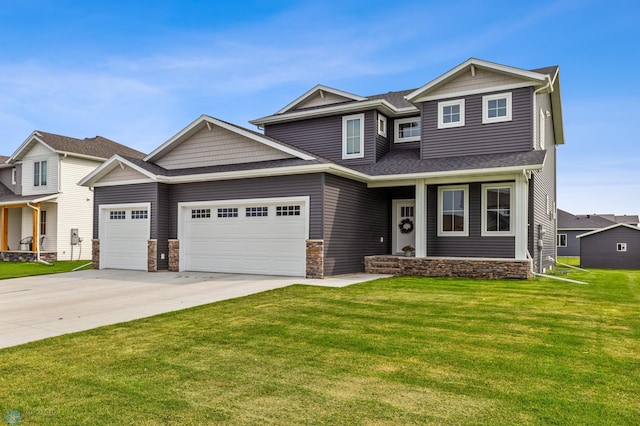 craftsman house featuring a garage and a front lawn