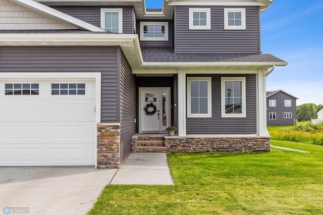 view of front of property with a garage and a front lawn